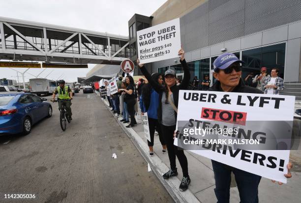 Rideshare drivers for Uber and Lyft stage a strike and protest at the LAX International Airport, over what they say are unfair wages in Los Angeles,...
