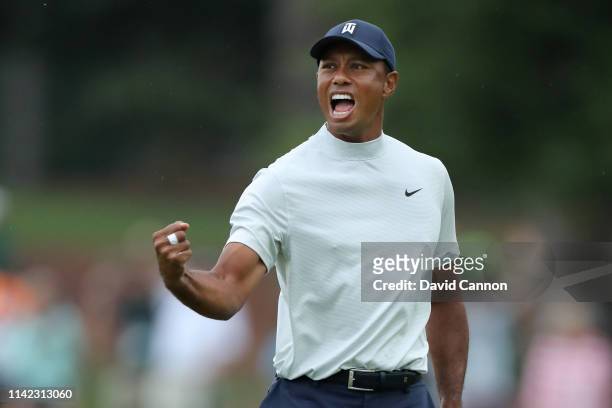 Tiger Woods of the United States celebrates after making a putt for birdie on the 15th green during the second round of the Masters at Augusta...