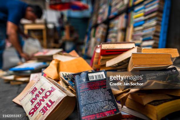 Used books are seen lying disorganized on the street in a secondhand bookshop on April 12, 2018 in San Salvador, El Salvador. Large collections of...