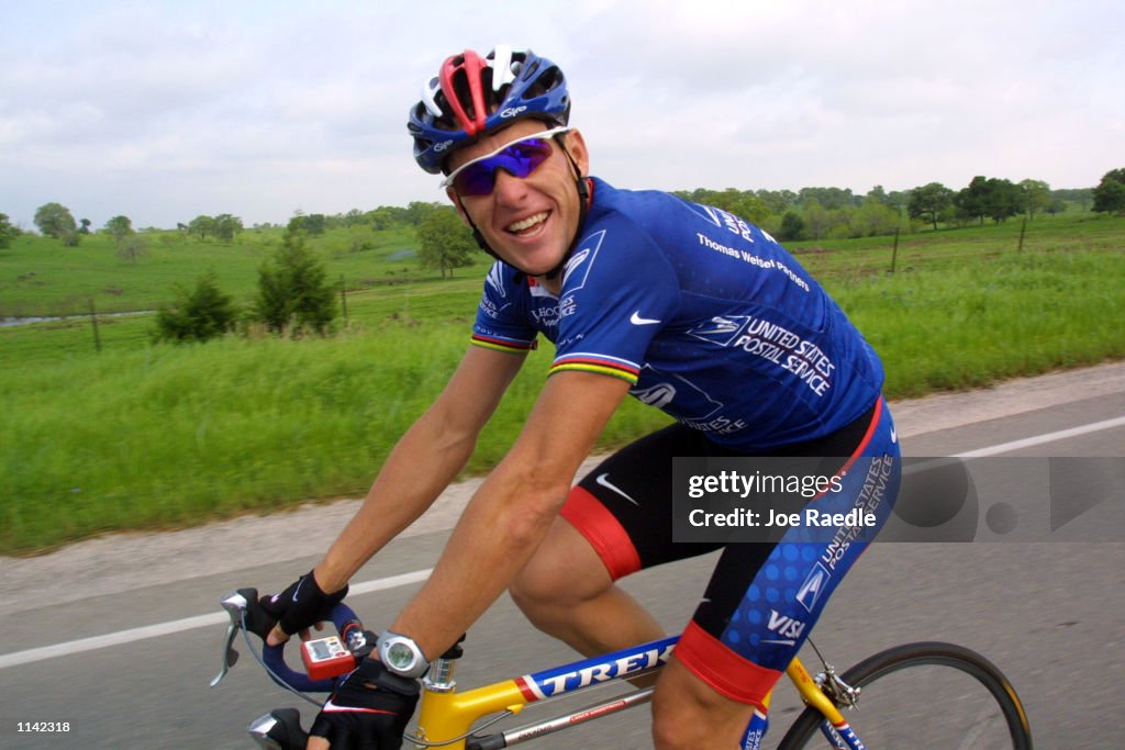 Cyclist Lance Armstrong pedals through the countryside during the