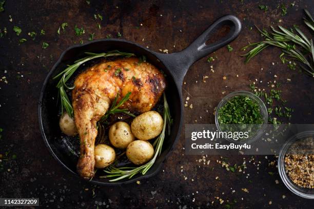 chiken leg and potatoes in a skillet - skillet stock pictures, royalty-free photos & images