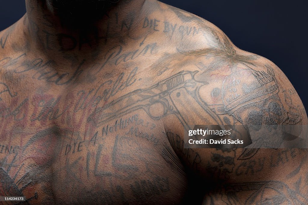 Man with tattoos, shoulder view