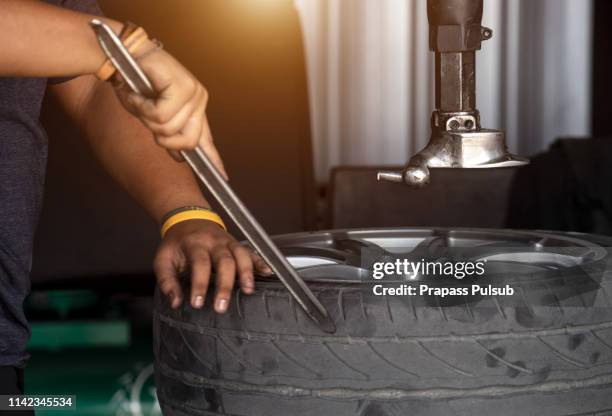 repairman balances the wheel and installs the tubeless tire of the car on the balancer in the workshop - tubeless tyres stock pictures, royalty-free photos & images