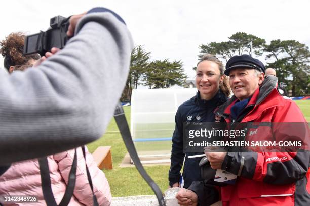 France's national football team midfielder Gaetane Thiney poses for pictures with supporters during a training session in Perros-Guirec, Brittany, on...