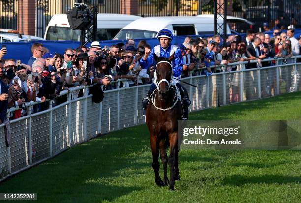 Hugh Bowman, riding champion racehorse Winx, gestures to the crowd after riding her final race to victory in the Queen Elizabeth Stakes at The...