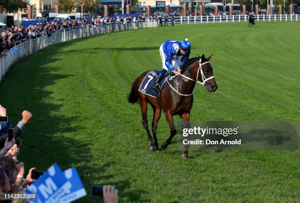 Hugh Bowman, riding champion racehorse Winx, gestures to the crowd after riding her final race to victory in the Queen Elizabeth Stakes at The...