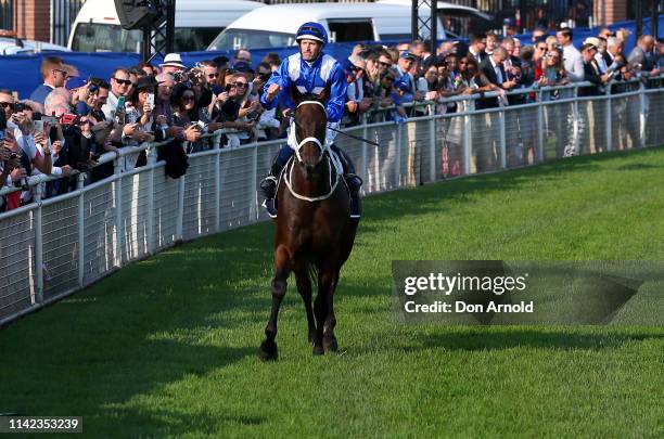 Hugh Bowman, riding champion racehorse Winx, gestures to the crowd after riding her final race to victory in the Queen Elizabeth Stakes at The...