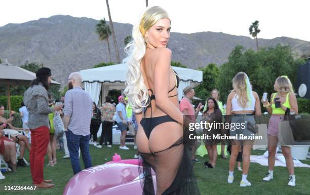 Ava Capra poses for portrait poolside at beGlammed Sunset Soiree Presented by Fullscreen on April 12, 2019 in Palm Springs, California.