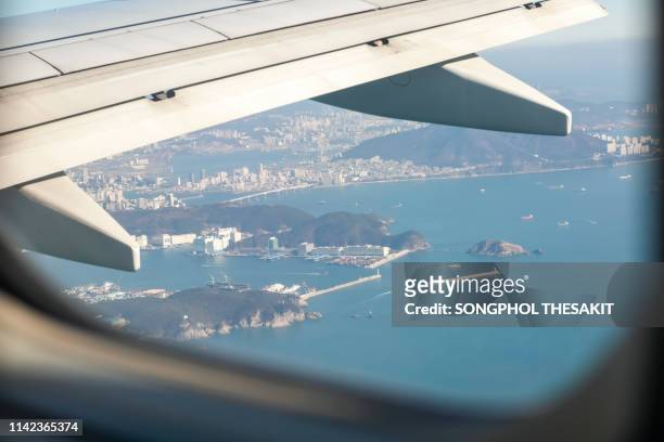 aerial view/airplane window view at busan, south korea from the sky. - southbound stock pictures, royalty-free photos & images