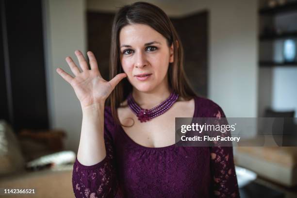 lovely deaf woman showing the hand sign for the mother - american sign language stock pictures, royalty-free photos & images