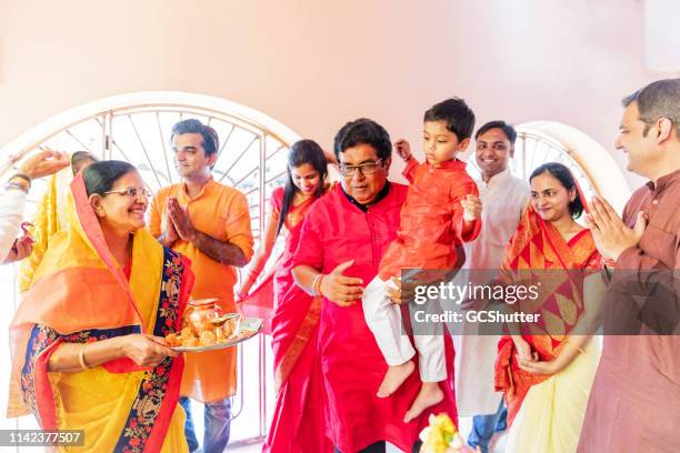multi-generation hindu family visiting a temple - diwali family stock pictures, royalty-free photos & images