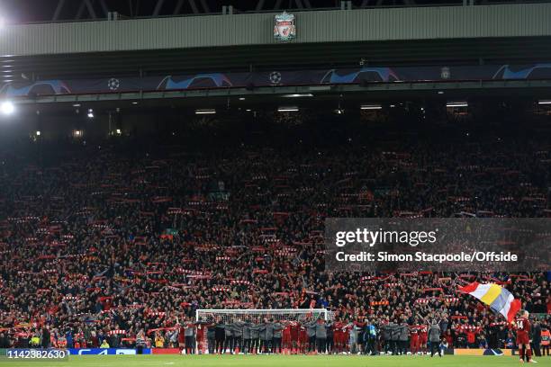 Liverpool fans in The Kop hold their scarves aloft as their players celebrate their victory after the UEFA Champions League Semi Final second leg...