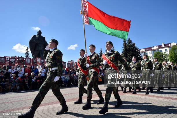 Belarus' cadets march past veterans during a military parade marking the 74th anniversary of the Soviet Union's victory over Nazi Germany, in the...