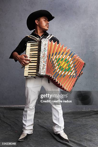 mexican guy playing the accordion - accordion instrument stock pictures, royalty-free photos & images