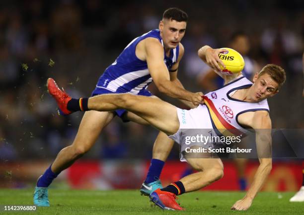 David Mackay of the Crows is tackled by Paul Ahern of the Kangaroos during the round four AFL match between the North Melbourne Kangaroos and the...