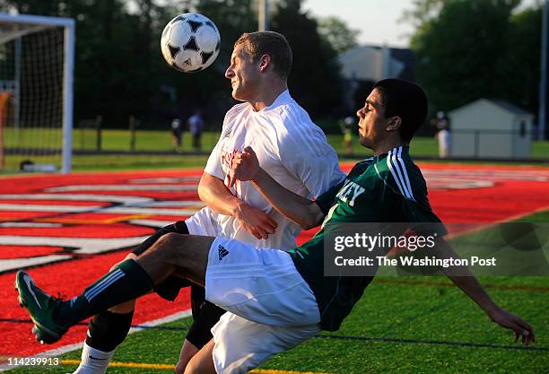 Herndon's Sam Eaddy and Langley's Nima Kassiri, foreground, go after the loose ball during their soccer match at Herndon High School in Herndon, Va....