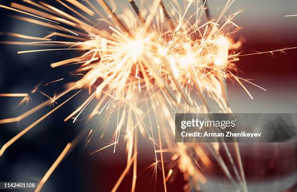 firework in front of american flag - american flag fireworks stock pictures, royalty-free photos & images