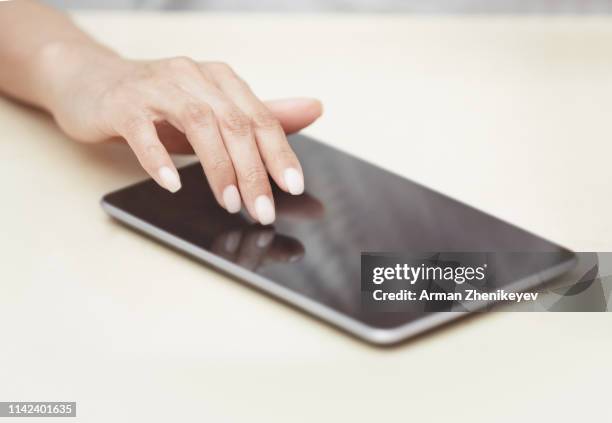 woman touching digital tablet - touchpad foto e immagini stock