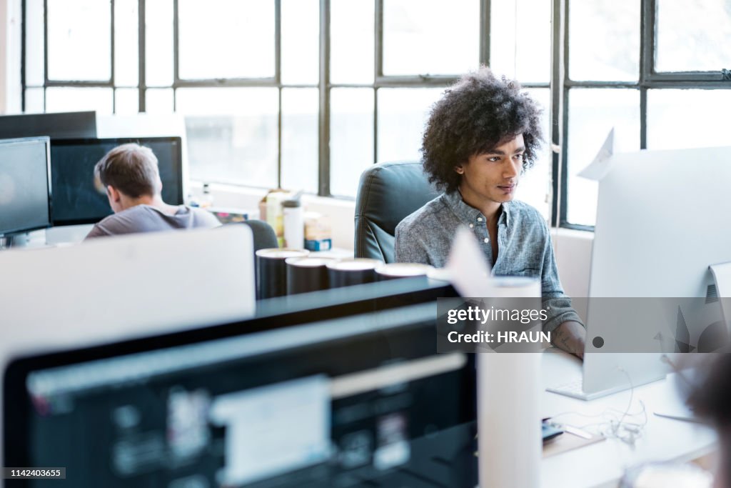 Using A Dec Computer Young Businessman Using Computer At Desk High-Res Stock Photo - Getty ...