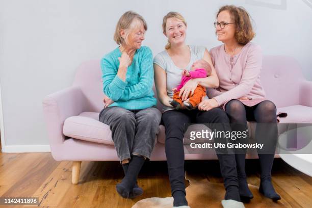 Bonn, Germany In this photo illustration a Mother, Grandmother and great-grandmother and a baby sitting on a sofa on March 15, 2019 in Bonn, Germany.