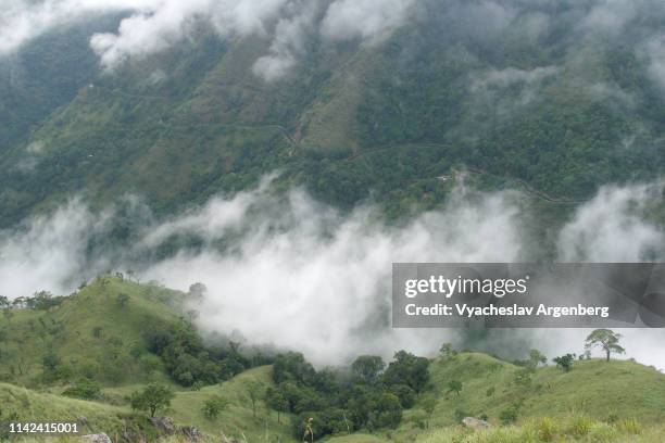 mountain valley in clouds, a view down the ella valley from side peaks, sri lanka - ella sri lanka stockfoto's en -beelden