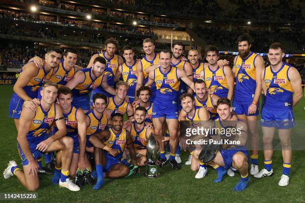 The Eagles pose with the RAC Derby trophy after winning the round four AFL match between the West Coast Eagles and the Fremantle Dockers at Optus...
