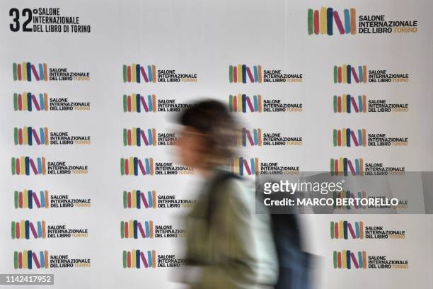 Visitor walks past the fair's poster on May 9, 2019 at the 32nd Turin International Book Fair in Turin.