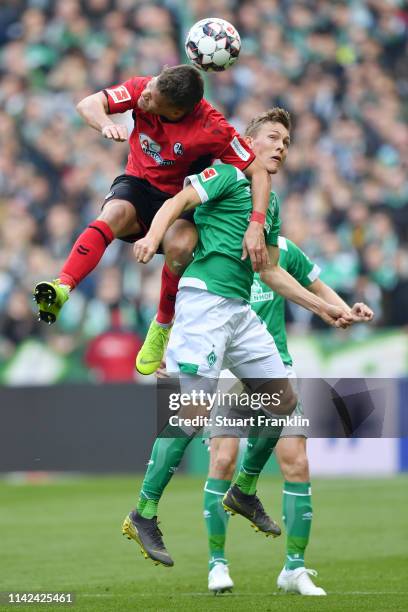 Florian Niederlechner of Freiburg wins a header over Ludwig Augustinsson of Werder Bremen during the Bundesliga match between SV Werder Bremen and...