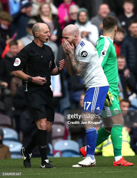 Aron Gunnarsson of Cardiff City argues with referee Mike Dean during the Premier League match between Burnley FC and Cardiff City at Turf Moor on...