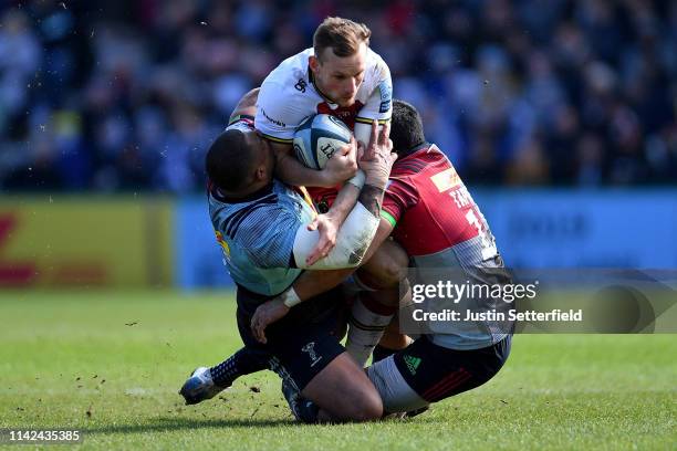 Rory Hutchinson of Northampton is tackled by Ben Tapuai of Harlequins and Kyle Sinckler of Harlequins during the Gallagher Premiership Rugby match...