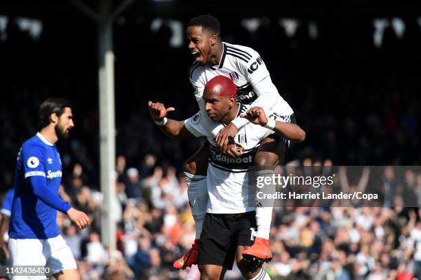Ryan Babel of Fulham celebrates with teammate Ryan Sessegnon after scoring his team's second goal during the Premier League match between Fulham FC...