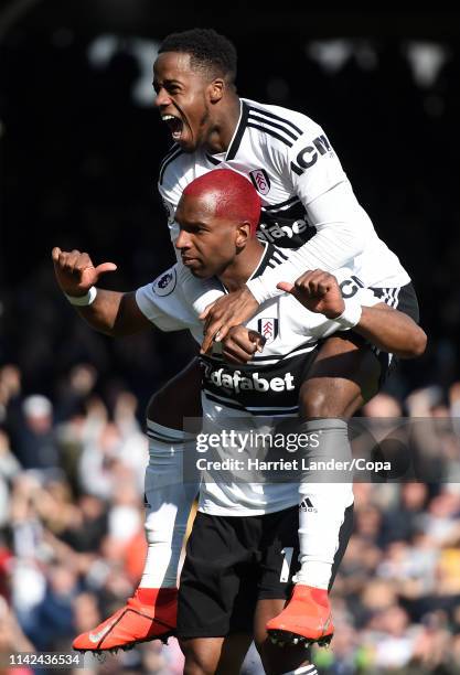 Ryan Babel of Fulham celebrates with teammate Ryan Sessegnon after scoring his team's second goal during the Premier League match between Fulham FC...