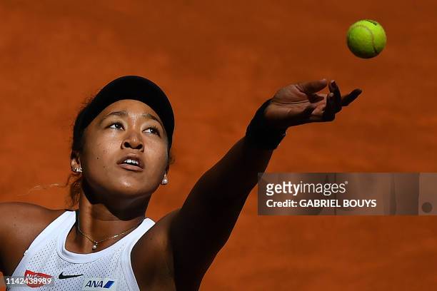 Japan's Naomi Osaka returns the ball to Switzerland's Belinda Bencic during their WTA Madrid Open round of 8 tennis match at the Caja Magica in...