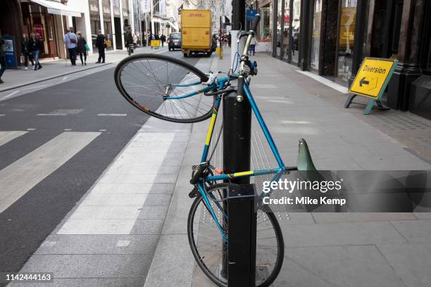 Bike d-locked high up a lampost on New Bond Street in Mayfair, London, England, United Kingdom.