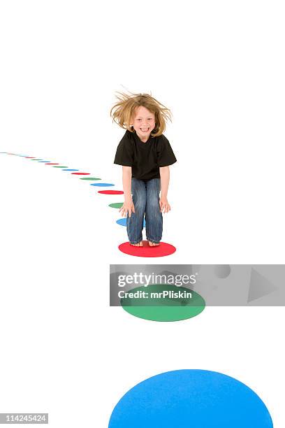 girl jumping on colourful circles - stepping stones stockfoto's en -beelden