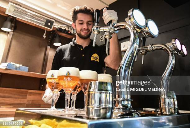 Waiter serves glasses of Belgian draught Leffe beer on May 8, 2019 at the TUTTOFOOD fair, the international B2B show dedicated to food and beverage...