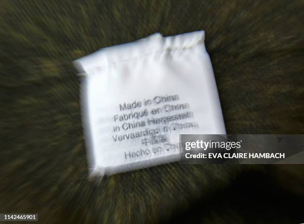 Photo illustration shows a label inside an item of clothing reading "Made in China" in several languages in Washington, DC on May 09, 2019. - US and...