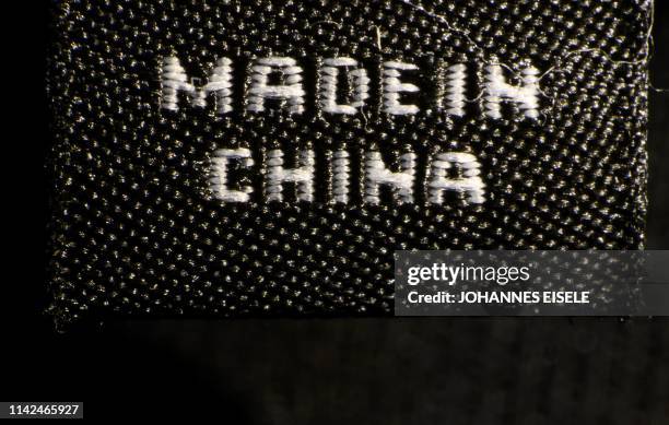 Photo illustration shows a label inside an item of clothing reading "Made in China" in New York on May 09, 2019. - US and Chinese officials resumed...