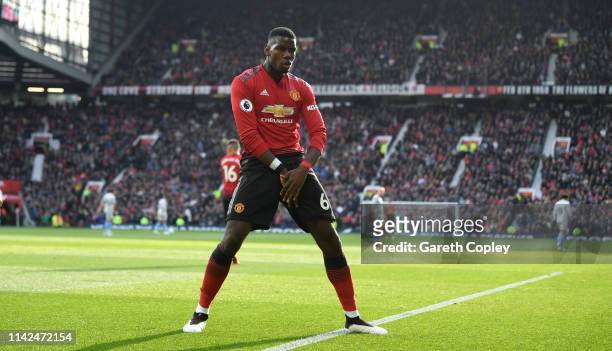 Paul Pogba of Manchester United celebrates as he scores his team's first goal from the penalty spot during the Premier League match between...