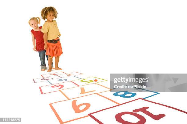 two young girls playing hopscotch - hopscotch stock pictures, royalty-free photos & images