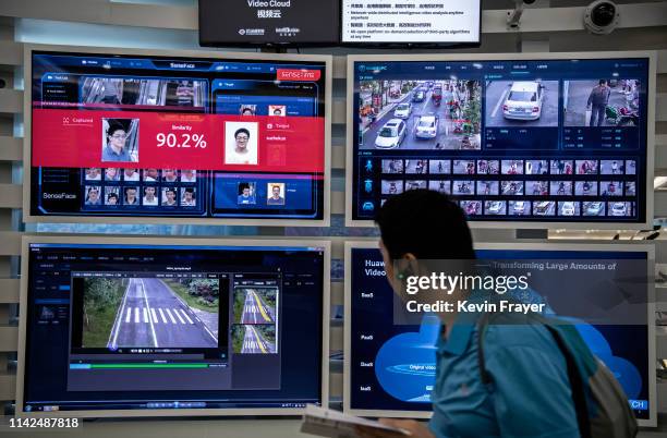 Display for facial recognition and artificial intelligence is seen on monitors at Huawei's Bantian campus on April 26, 2019 in Shenzhen, China....