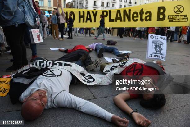 Group of activists from extinction rebellion seen lying on the ground pretending to be dead during a performance. Extinction Rebellion activists...