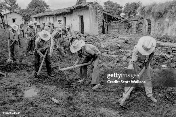 Villagers paid with U.S. Aid money to rebuild San Lorenzo, San Vicente Department, El Salvador, 1983.