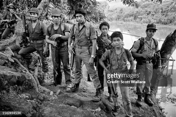 Rebels of the Farabundo Marti National Liberation Front at the point of a ferry crossing, La Anchila, Usulutan, El Salvador 1983.