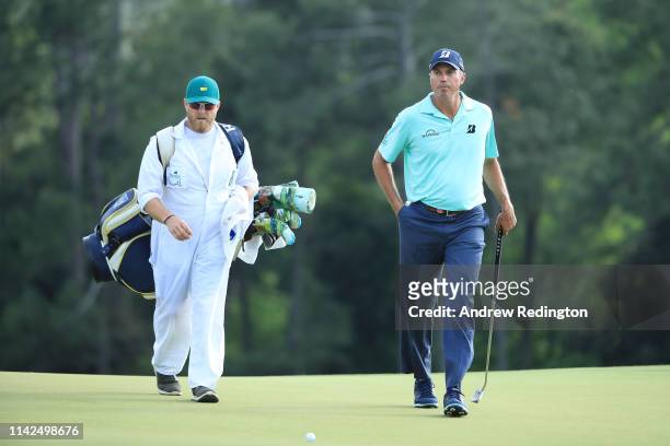 Matt Kuchar of the United States walks with caddie John Wood during the third round of the Masters at Augusta National Golf Club on April 13, 2019 in...