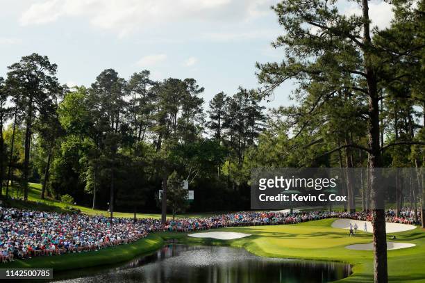 General view as Tiger Woods of the United States stands on the 16th green during the third round of the Masters at Augusta National Golf Club on...