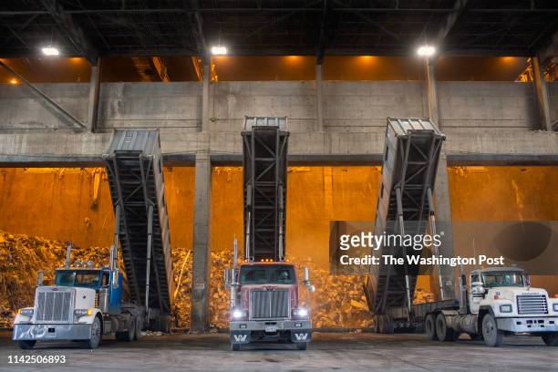 Dickerson, MD Trucks equipped with special containers that can hold up to 25 tons of garbage dump the contents in the tipping hall of the Covanta...