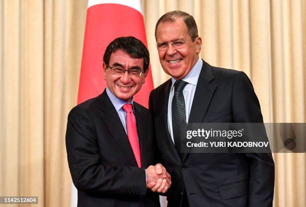 Russian Foreign Minister Sergei Lavrov shakes hands with Japanese Foreign Minister Taro Kono after their news conference in Moscow on May 10, 2019.