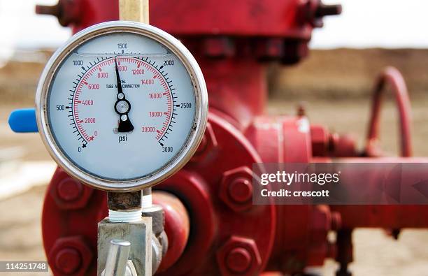 close-up of the meter of a red wellhead pressure gauge - oil pipeline stock pictures, royalty-free photos & images