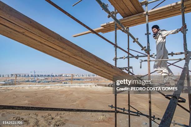 Bricklayer is working on a mosque construction site, it the new administrative capital, some 50 km east of the capital Cairo, on March 8, 2019